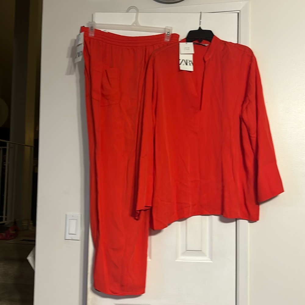 Pant set in red-orange. Never worn